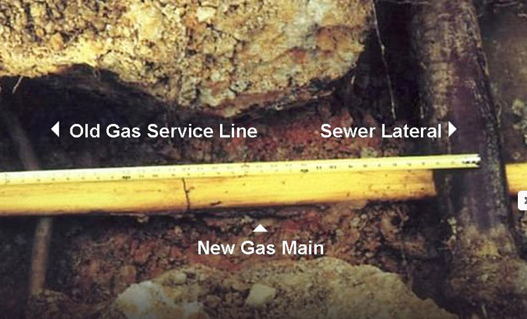 A PVC natural gas pipe with examples of sewer, old and new gas mainlines.